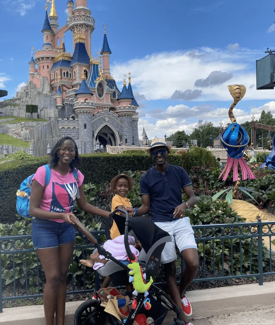 Claude Buzizi with his wife and children in front of the castle at Disneyland Paris.